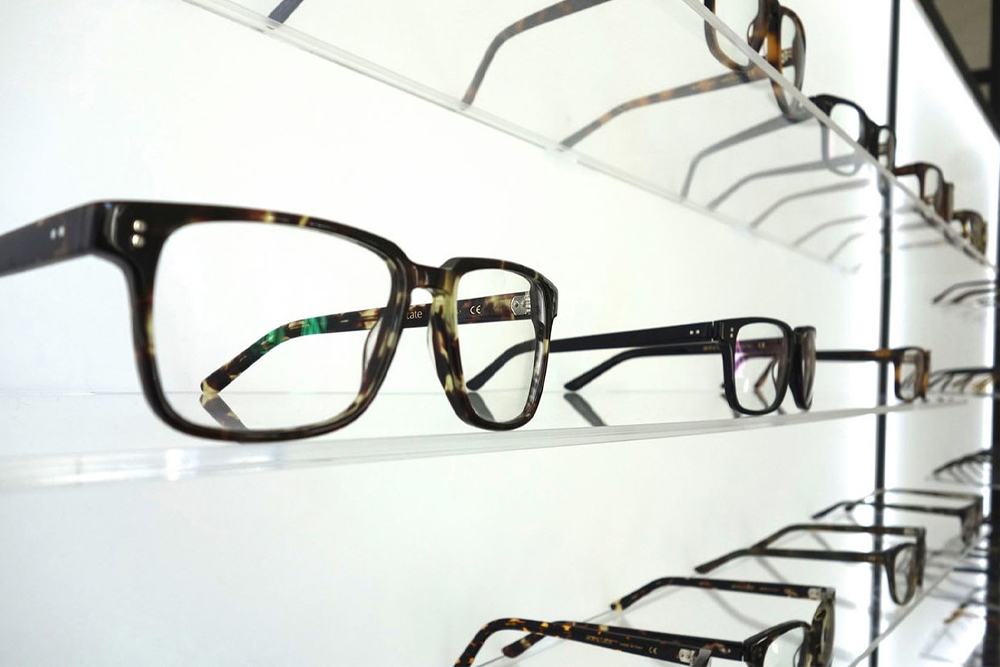 Display of designer eyeglass frames at DeCarlo Optometry, offering styles that complement various face shapes.