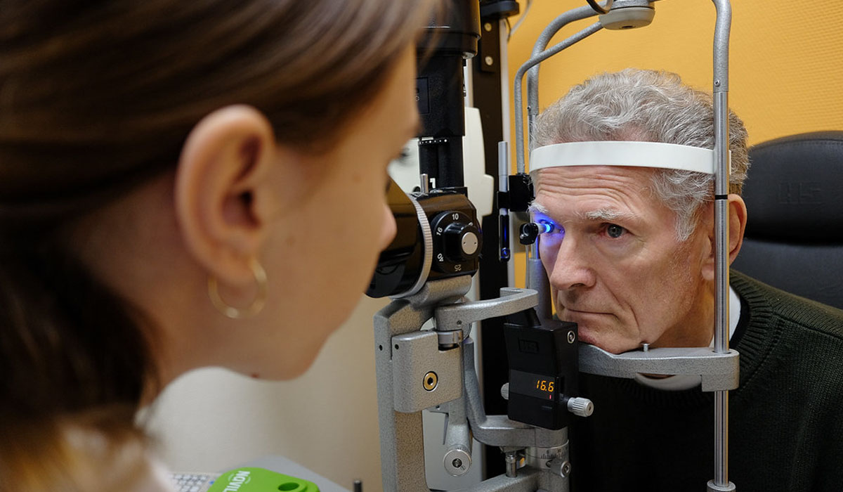 a-female-ophthalmologist-using-eye-testing-equipment-to-examine-the-man's-eyes