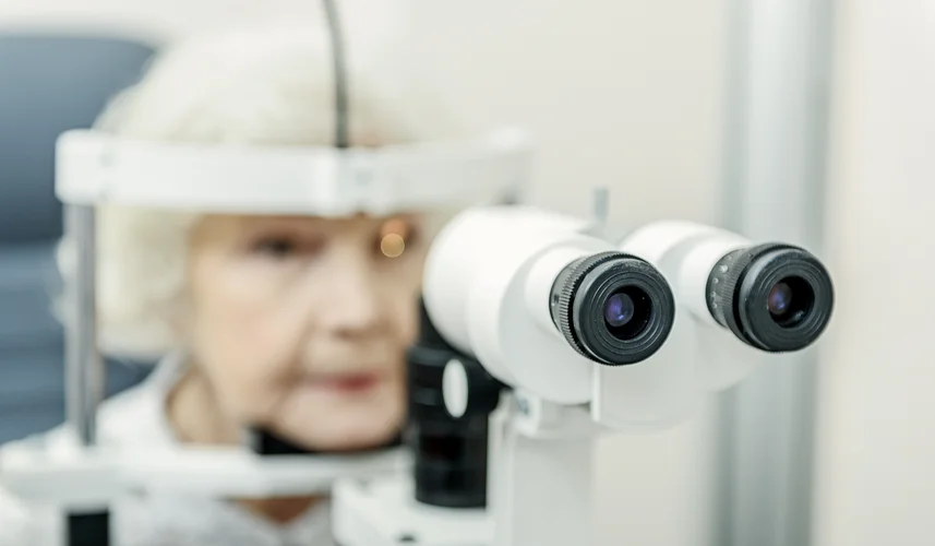 Ophthalmologist checking eyesight of senior patient in eye clinic.