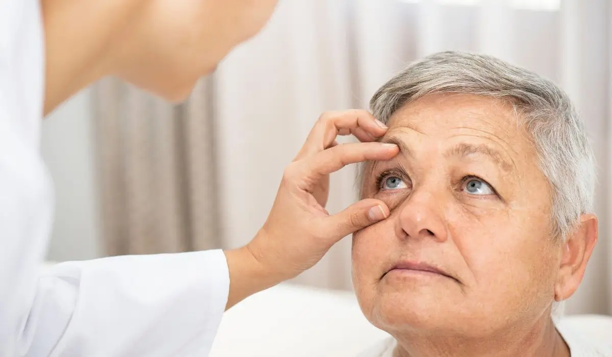 Optometrist examining an elderly woman's eyes, checking for vision issues and promoting overall eye health awareness.