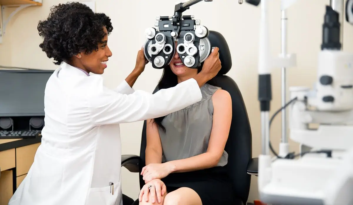 Female optometrist assisting a first-time patient during a detailed eye exam at a modern clinic in Placentia.