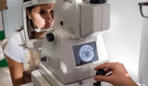 Optometrist performing advanced vision screenings using retinal imaging equipment to detect eye conditions beyond eyesight clarity.